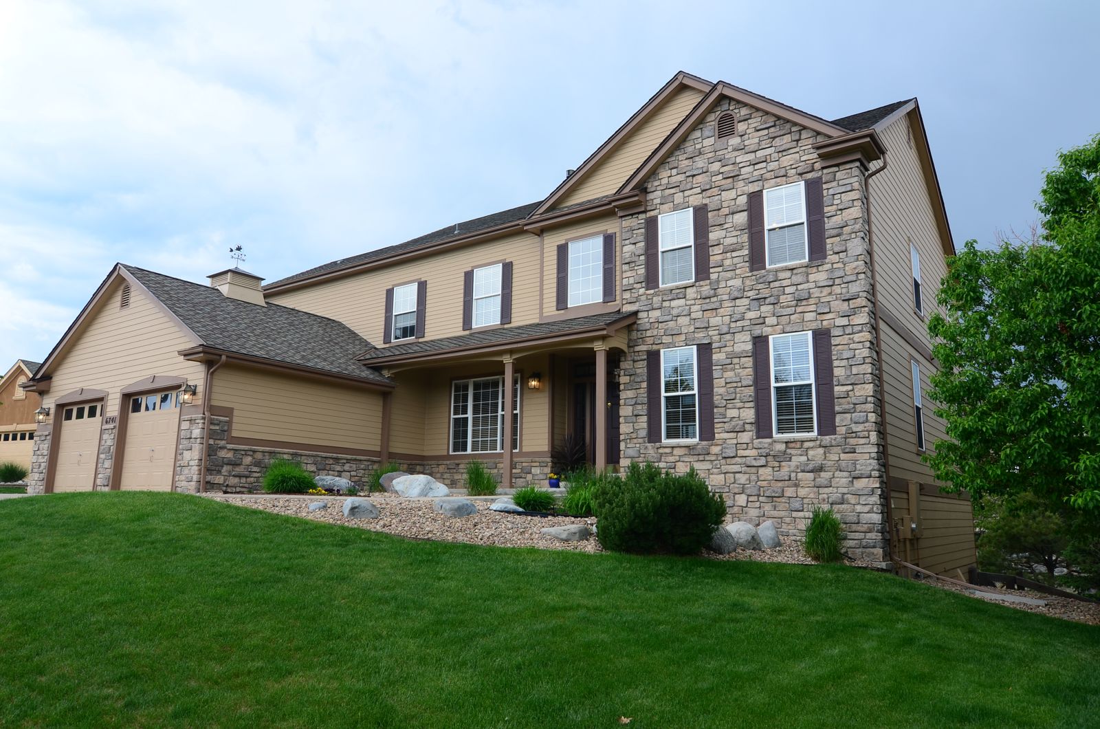 Two-story stone and siding home in Castle Pines, CO