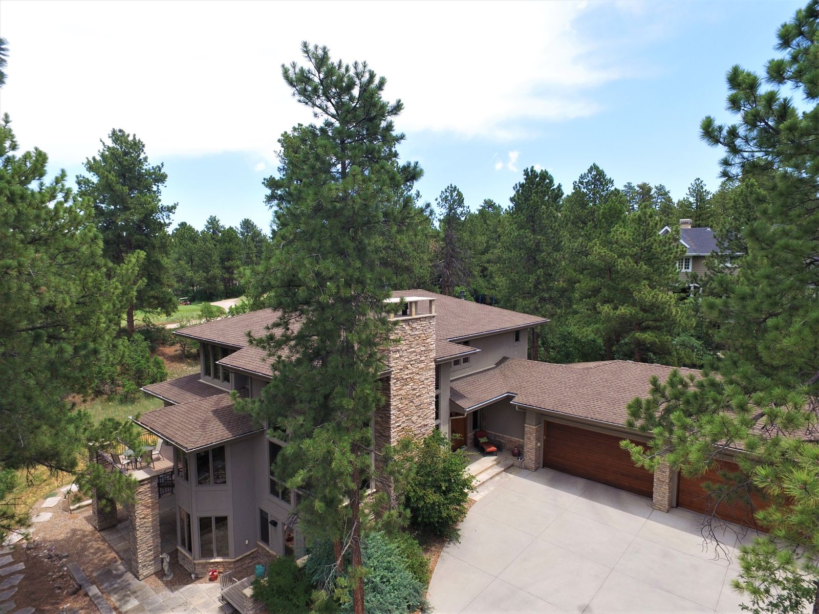 Aerial view of a Castle Pines Village home among ponderosa pines