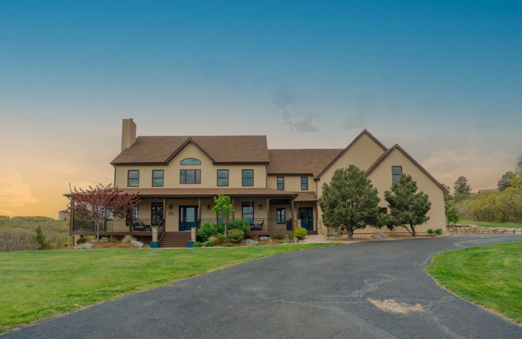 Two-story home with a wraparound porch on Colt Circle in Keene Ranch, Castle Rock, CO