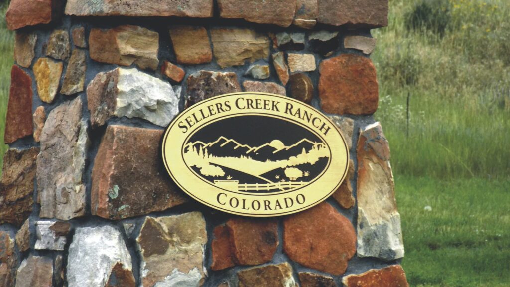 Sellers Creek Ranch entrance sign on a stone pillar, Castle Rock, CO