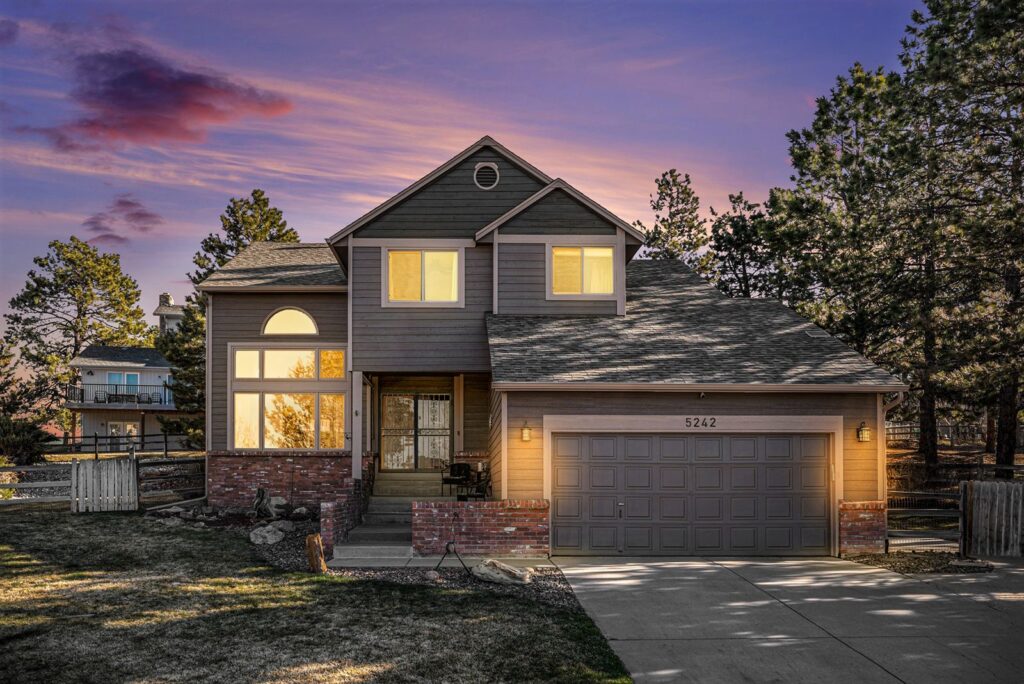 Twilight exterior of a two-story home in The Pinery, Parker, CO, sold by the Joan Pratt Group